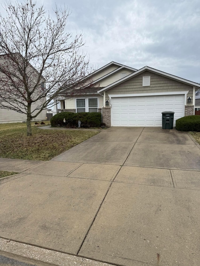 ranch-style home with an attached garage, brick siding, and driveway