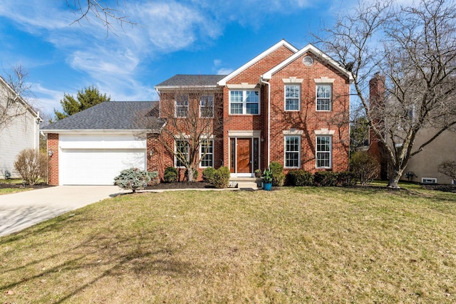 colonial-style house with a garage, brick siding, concrete driveway, and a front yard