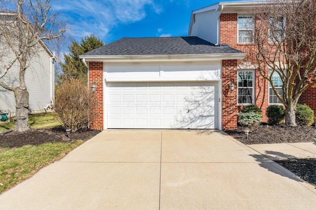 view of front of home featuring concrete driveway, an attached garage, brick siding, and a shingled roof