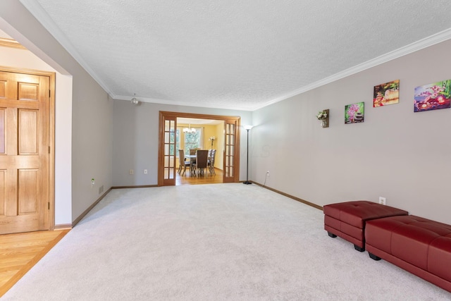 interior space featuring baseboards, a textured ceiling, and ornamental molding