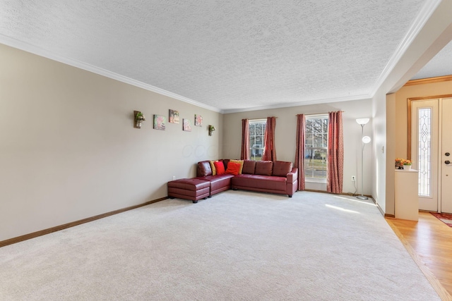 living room with light colored carpet, baseboards, a textured ceiling, and crown molding