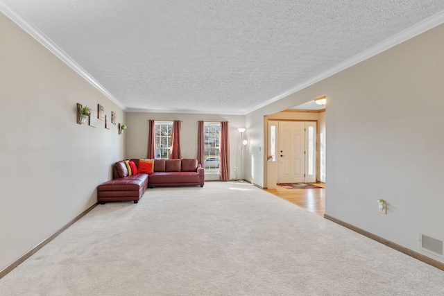 living area with visible vents, light colored carpet, baseboards, and ornamental molding