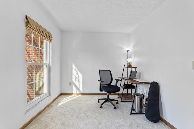 office with baseboards, carpet, and a textured ceiling