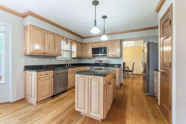 kitchen with a sink, stainless steel appliances, light brown cabinetry, and light wood finished floors