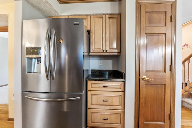 kitchen featuring wood finished floors and stainless steel fridge with ice dispenser