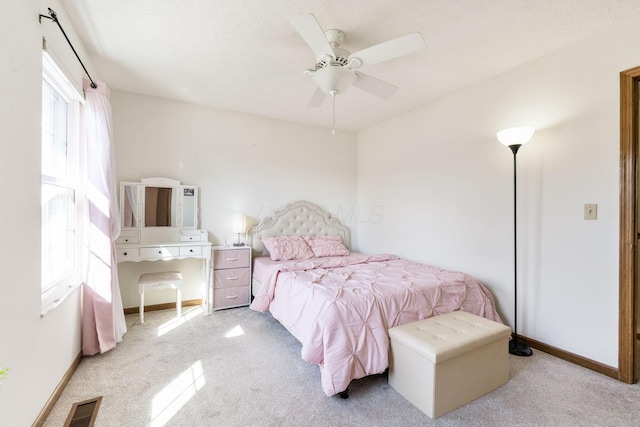 bedroom with ceiling fan, carpet, visible vents, and baseboards