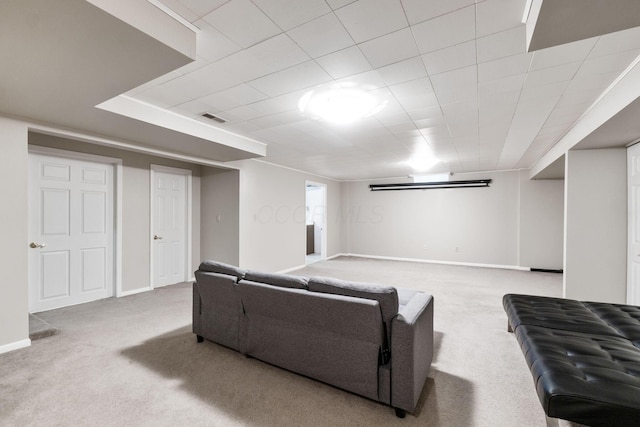 carpeted living room featuring visible vents and baseboards