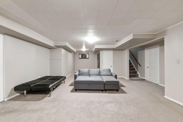 living area featuring stairs, baseboards, carpet flooring, and crown molding