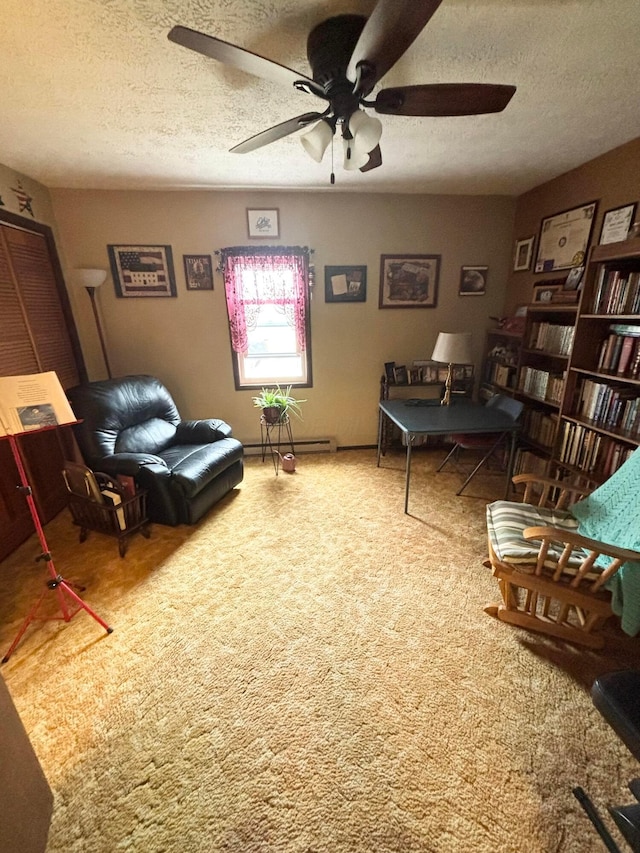 living room featuring a textured ceiling, carpet, a ceiling fan, and a baseboard radiator