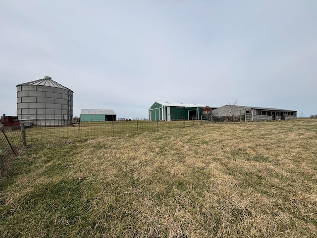 view of yard with an outbuilding and fence