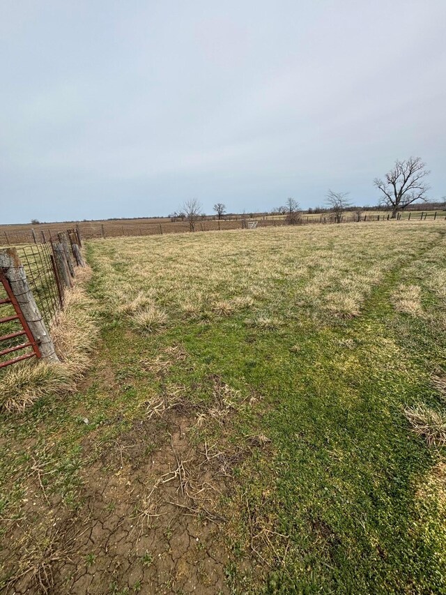 view of yard featuring a rural view and fence