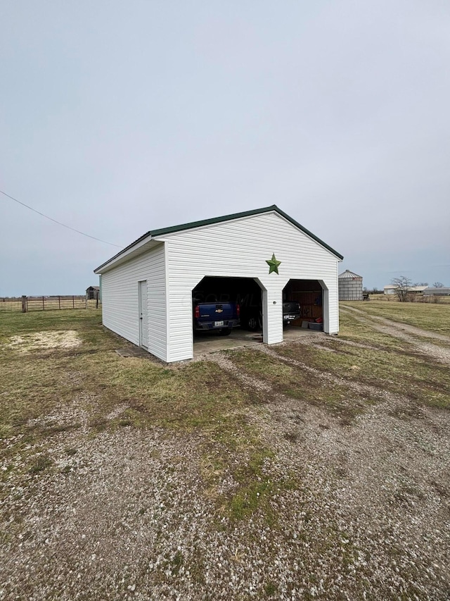 detached garage featuring fence