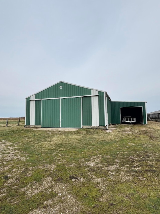 view of pole building featuring fence