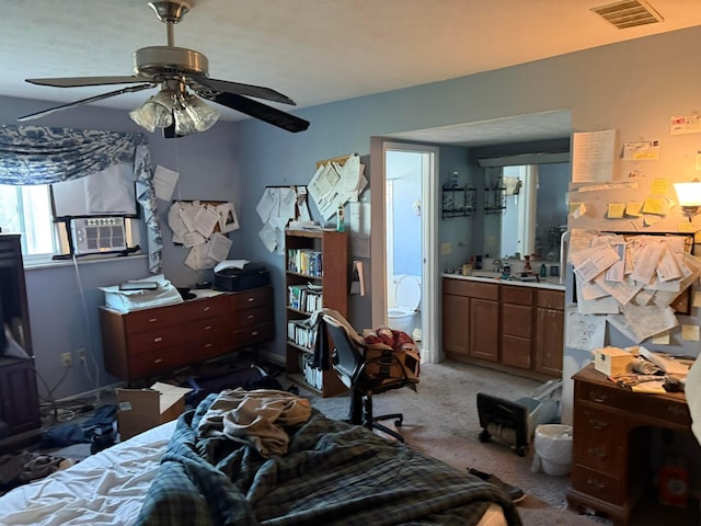 carpeted bedroom with visible vents, connected bathroom, cooling unit, and a ceiling fan