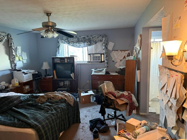 carpeted bedroom featuring cooling unit and a ceiling fan