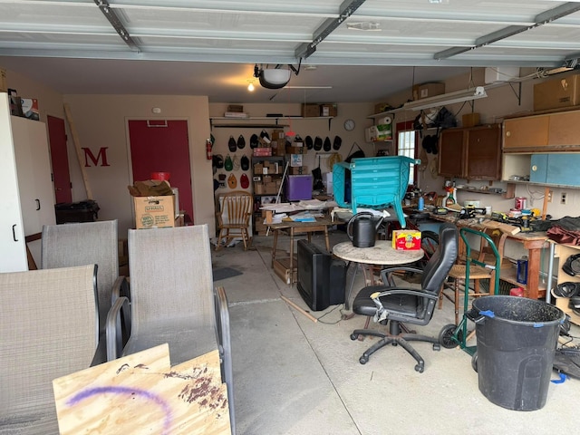 garage with a workshop area and a garage door opener