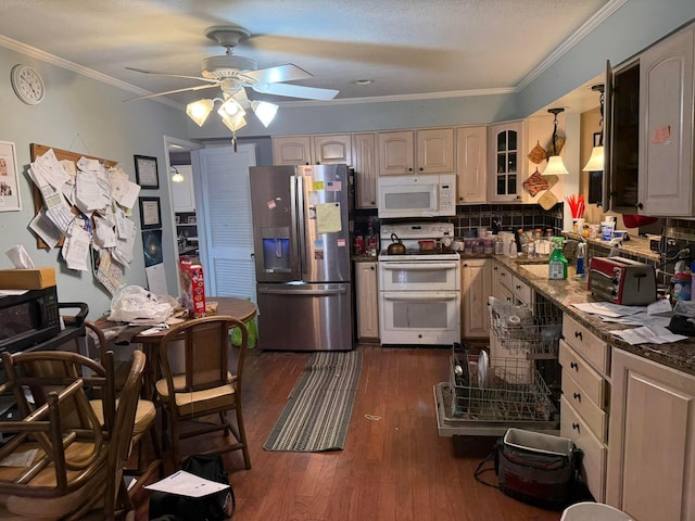 kitchen with white appliances, a ceiling fan, dark wood-type flooring, crown molding, and backsplash