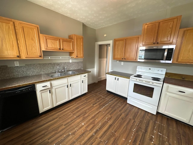 kitchen featuring a sink, stainless steel microwave, dark countertops, white electric range oven, and dishwasher