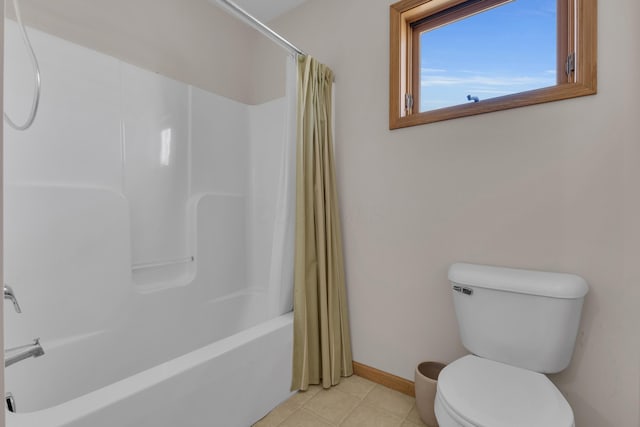 bathroom featuring tile patterned flooring, shower / bath combo with shower curtain, toilet, and baseboards