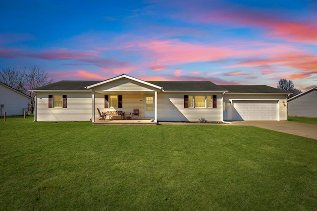 ranch-style home featuring a yard, a garage, and driveway