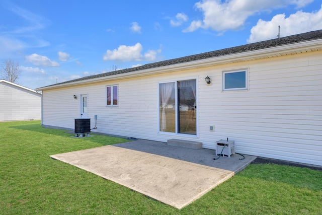 back of house with a patio area, central AC unit, and a yard