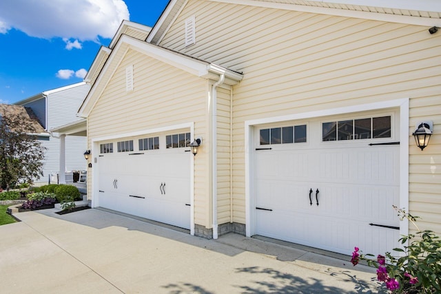 view of home's exterior featuring driveway and a garage