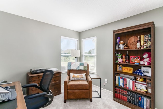 carpeted office space featuring baseboards