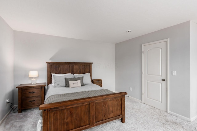 bedroom featuring baseboards and light colored carpet