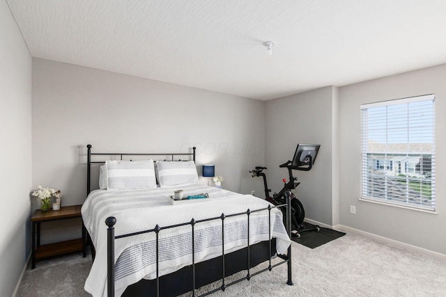 bedroom featuring carpet flooring and baseboards