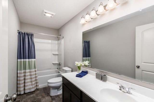 full bathroom with stone finish flooring, toilet, shower / bath combo, and vanity