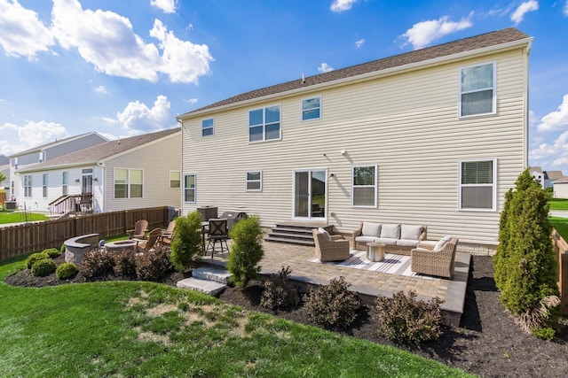 rear view of house with a patio, fence, a yard, an outdoor living space with a fire pit, and central AC unit