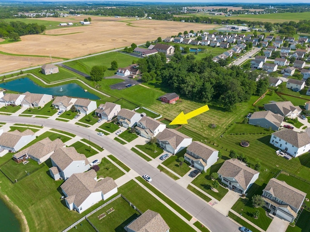 drone / aerial view with a residential view and a water view