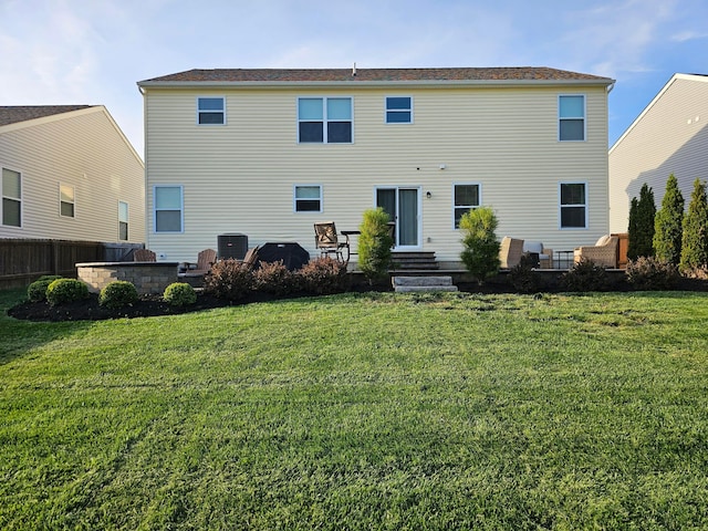 back of property featuring a yard, a patio area, cooling unit, and entry steps