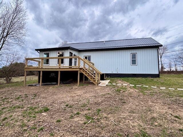 rear view of property featuring a deck, stairway, and crawl space