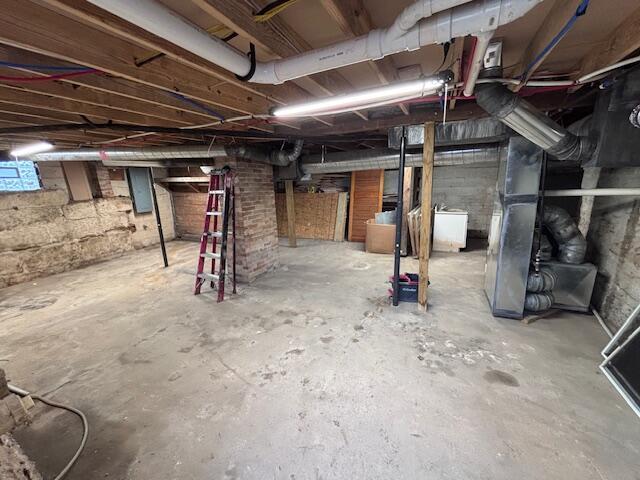 unfinished basement with washer / clothes dryer