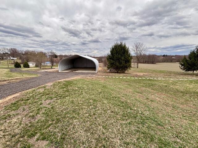 view of yard with a detached carport and driveway