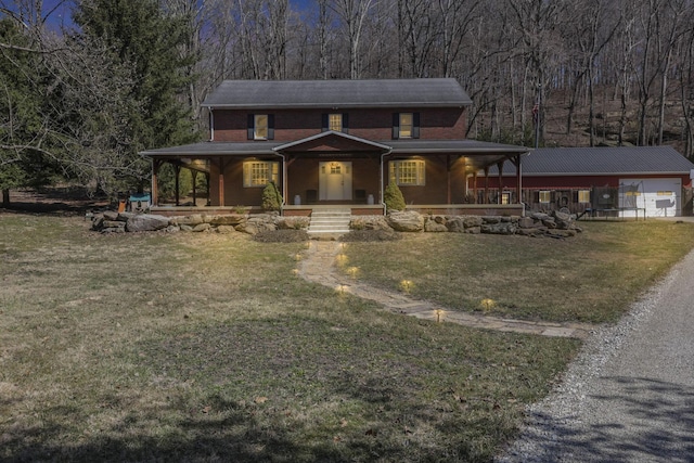 view of front of property with a porch, driveway, and a front lawn