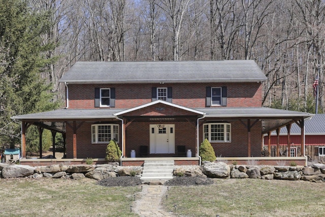 farmhouse-style home with a porch and brick siding