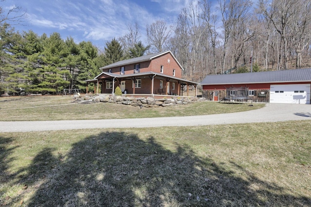 view of front of home featuring a garage, driveway, brick siding, and a front lawn