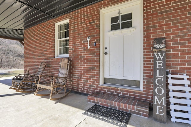 property entrance with brick siding