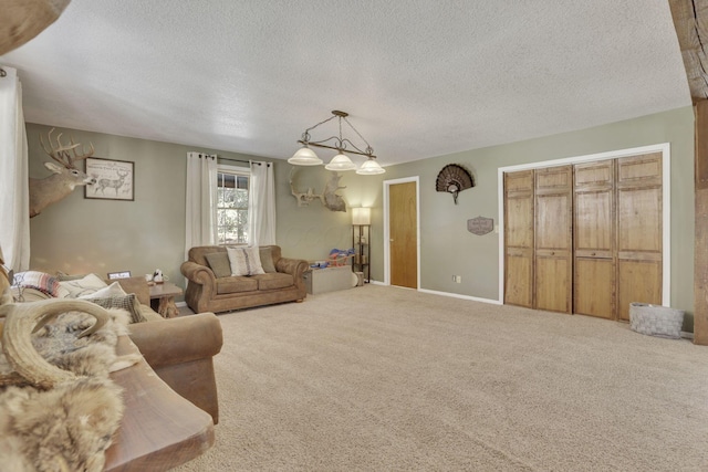 carpeted living area with baseboards and a textured ceiling