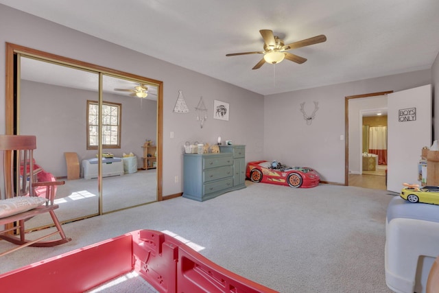 carpeted bedroom with baseboards, a closet, and ceiling fan