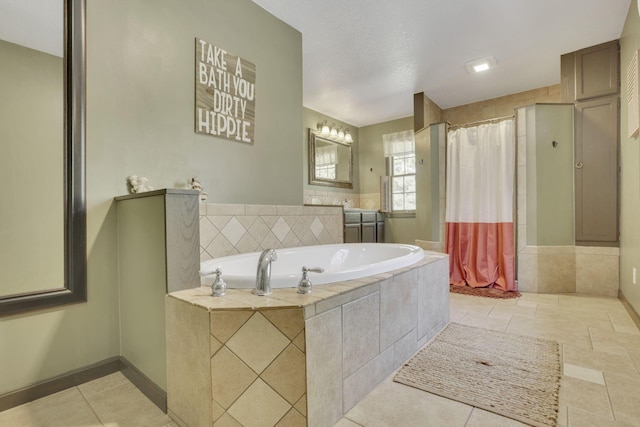 bathroom with a tile shower, tile patterned flooring, a bath, and baseboards