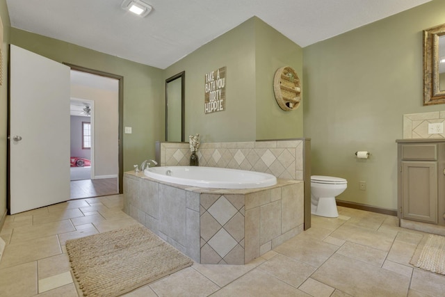 full bath with vanity, a bath, baseboards, tile patterned floors, and toilet