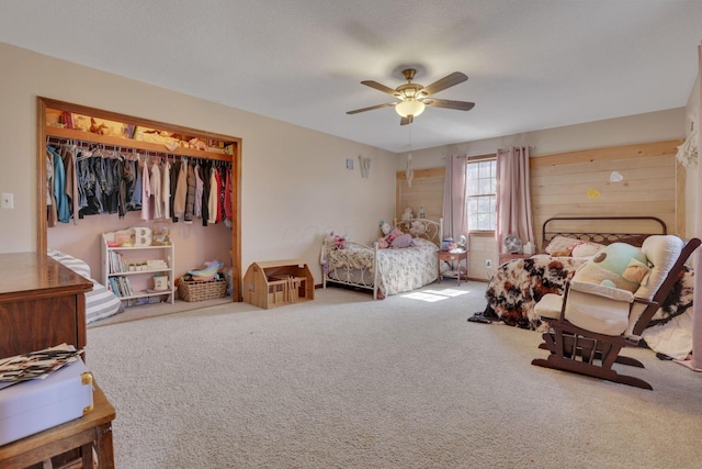 carpeted bedroom with a closet and ceiling fan