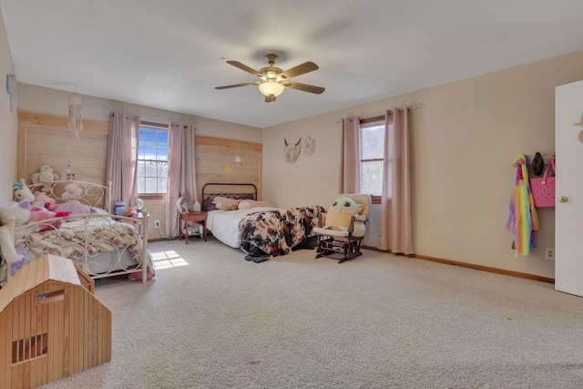 carpeted bedroom featuring baseboards and ceiling fan