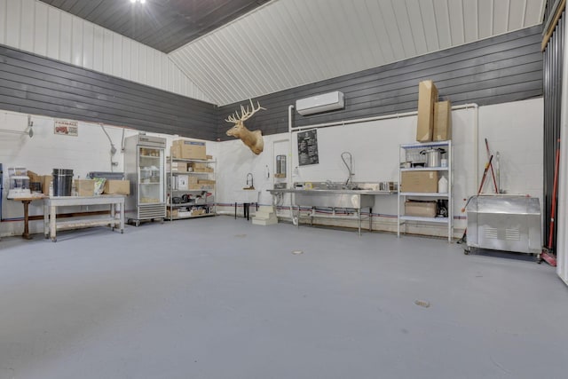 garage with concrete block wall and a wall mounted AC