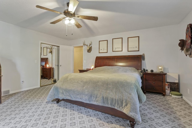 bedroom with visible vents, carpet floors, baseboards, and ceiling fan