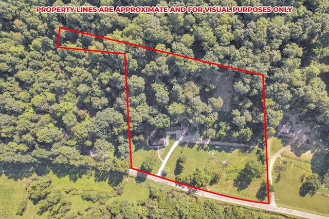 birds eye view of property with a wooded view