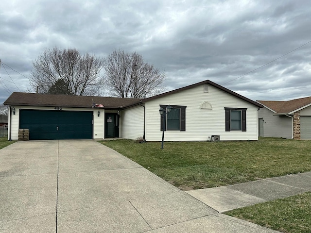 single story home with an attached garage, concrete driveway, and a front lawn